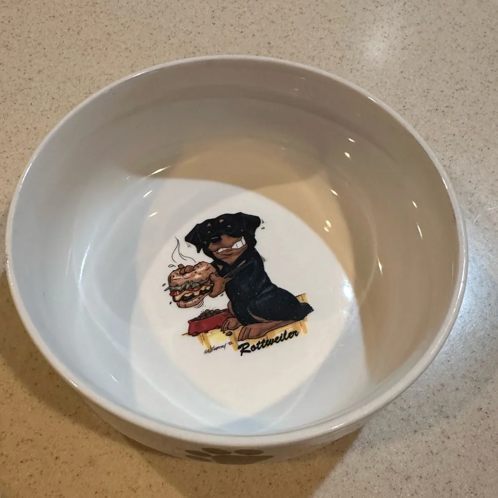 Rosalinde white dog bowl with Rottweiler and paw prints decor. Good shape.